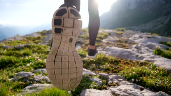 Hiker’s shoe on rocky terrain, ideal setting for using lightweight, durable rolling paper during outdoor adventures