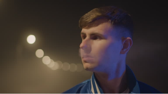 Individual in a moody nighttime setting (the ambiance linked to experiences with flavor bead rolling papers)
